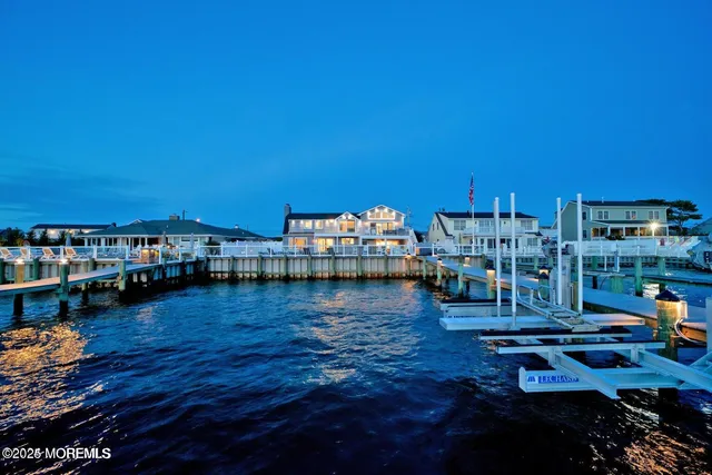 a spacious bedroom with a bed and a view of kitchen