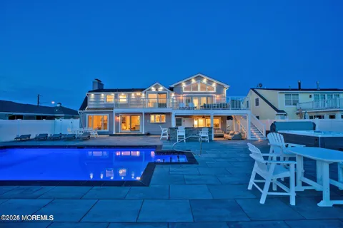 a living room with furniture and a view of kitchen