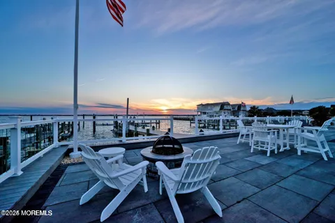 a kitchen with granite countertop white cabinets and stainless steel appliances