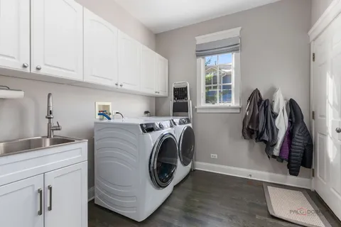 a utility room with sink dryer and washer