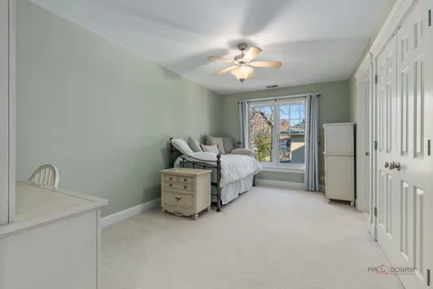 a spacious bedroom with a bed and a window