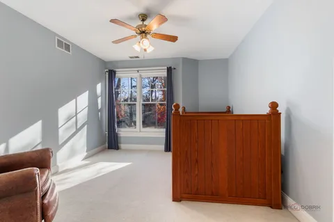 a view of a livingroom with a furniture and chandelier fan