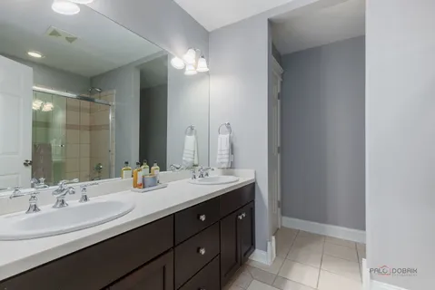a bathroom with a double vanity sink and a mirror