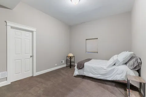a bedroom with a bed and chair