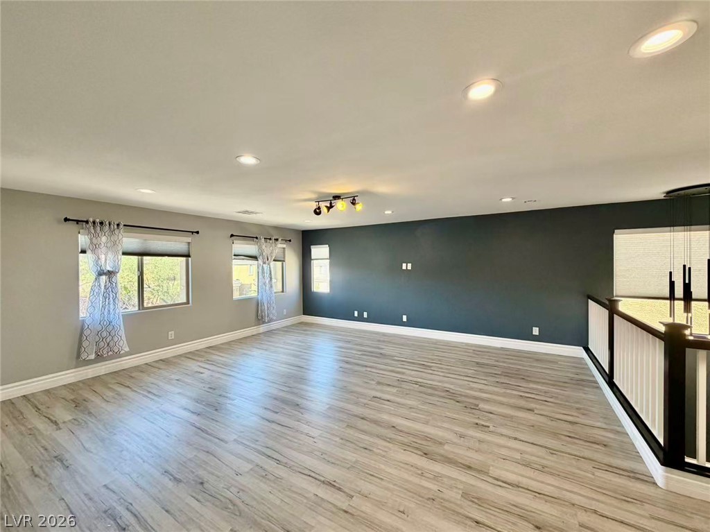 135 Tall Ruff Drive Las Vegas, NV 89148 - Photo 14 of 29 Luminous living area showcasing recessed lighting and beautiful wood flooring.