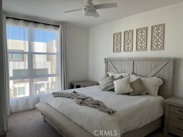 a bedroom with a large bed and a large window