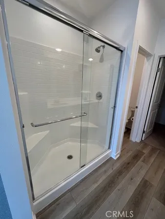 a bathroom with a glass shower door