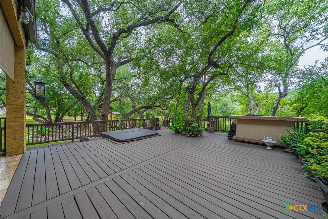 519 Long Meadow Spring Branch, TX 78070 - Photo 27 of 33 a view of a deck with a table and chairs and wooden floor