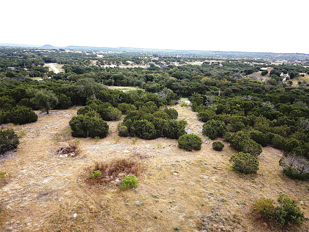 1096 Creek Crossing Road Nemo, TX 76070 - Photo 4 of 16 a view of a dry yard with mountains in the background