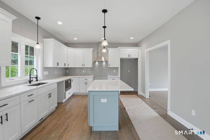 796 Maple Hill Road Naugatuck, CT 06770 - Photo 6 of 35 a large kitchen with kitchen island a large counter space a sink appliances and cabinets