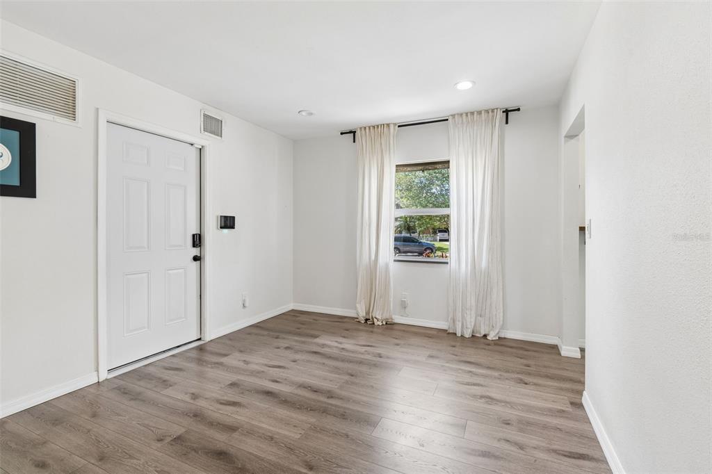 8043 124th Street North Seminole, FL 33772 - Photo 21 of 68 an empty room with wooden floor and windows