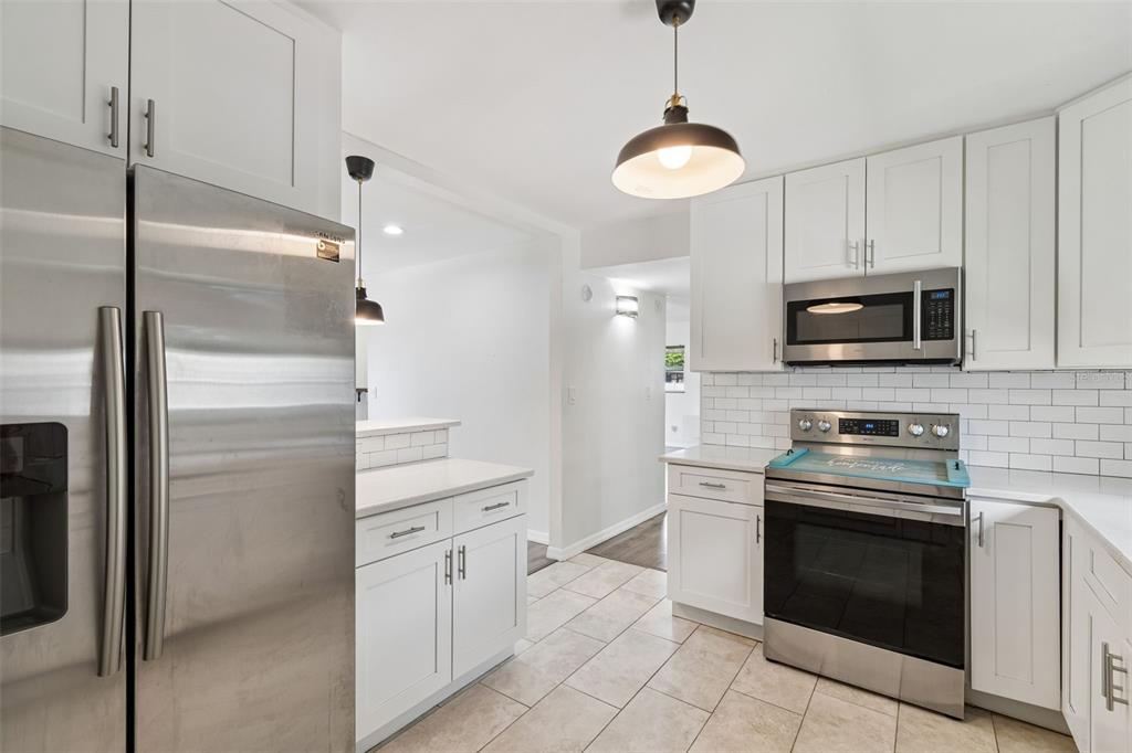 8043 124th Street North Seminole, FL 33772 - Photo 28 of 68 a kitchen with cabinets stainless steel appliances and a counter space
