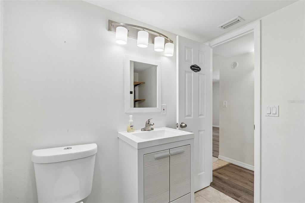 8043 124th Street North Seminole, FL 33772 - Photo 32 of 68 a bathroom with a sink a toilet and a mirror