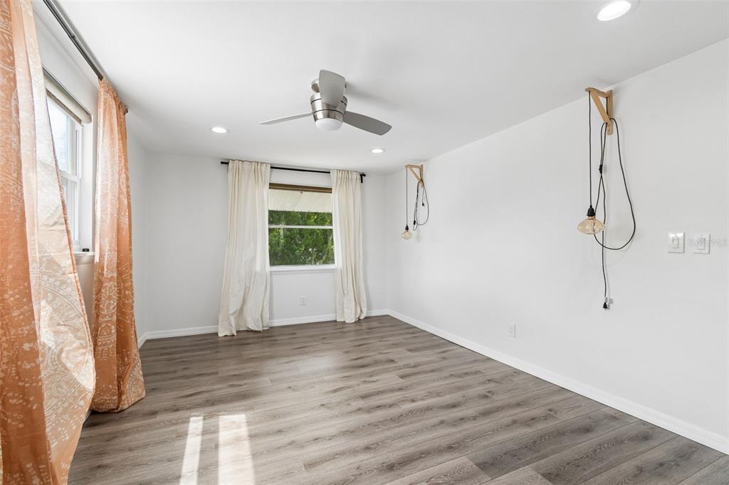 8043 124th Street North Seminole, FL 33772 - Photo 47 of 68 a view of empty room with wooden floor and fan