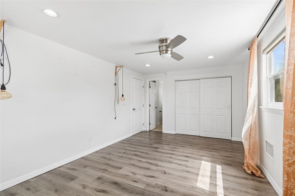 8043 124th Street North Seminole, FL 33772 - Photo 48 of 68 a view of empty room with wooden floor and fan