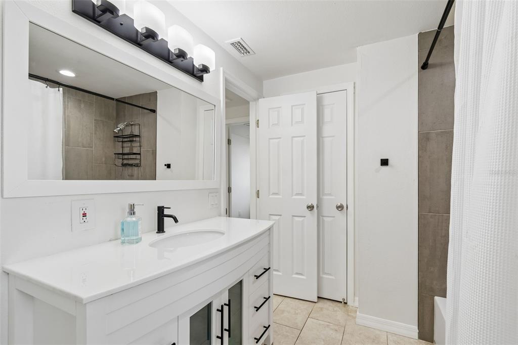 8043 124th Street North Seminole, FL 33772 - Photo 50 of 68 a bathroom with a sink and a mirror