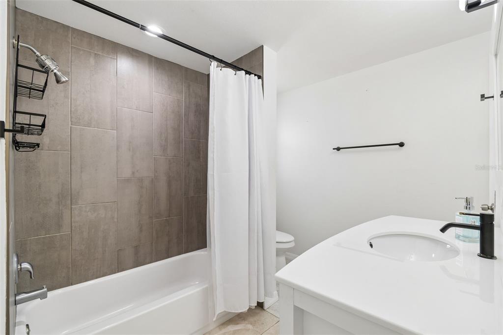 8043 124th Street North Seminole, FL 33772 - Photo 51 of 68 a bathroom with a sink a toilet and shower