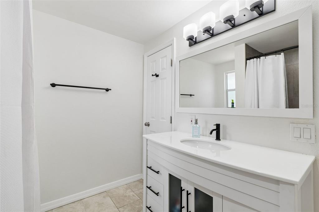 8043 124th Street North Seminole, FL 33772 - Photo 53 of 68 a bathroom with a sink and a mirror