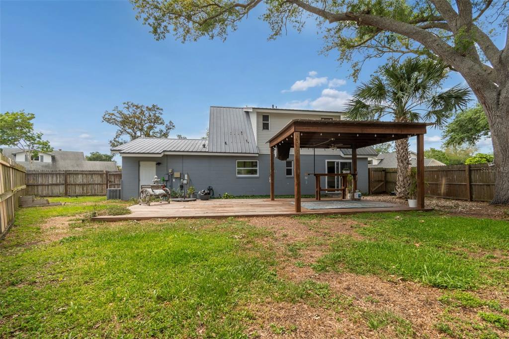 8043 124th Street North Seminole, FL 33772 - Photo 62 of 68 a view of a house with swimming pool and a yard