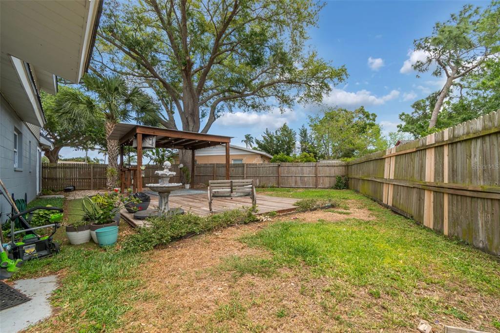8043 124th Street North Seminole, FL 33772 - Photo 63 of 68 a view of backyard with table and chairs and potted plants