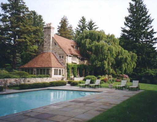 a view of a house with pool and sitting area