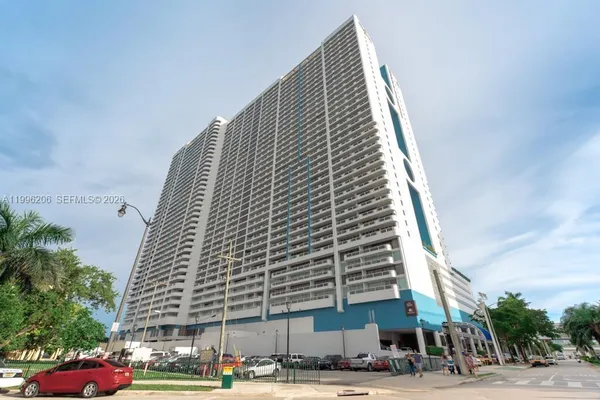 a view of a tall building next to a road