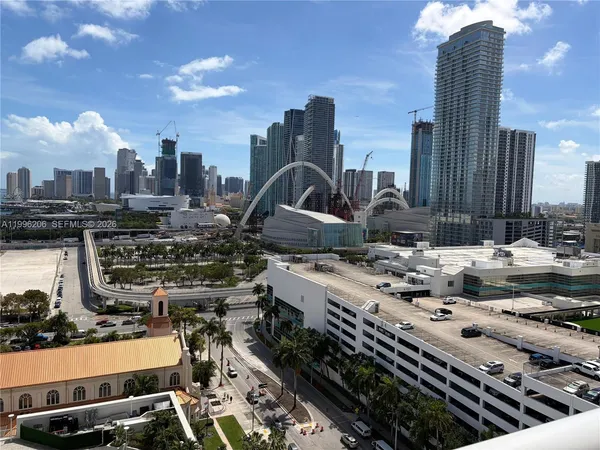 a kitchen with stainless steel appliances a counter top space and a refrigerator