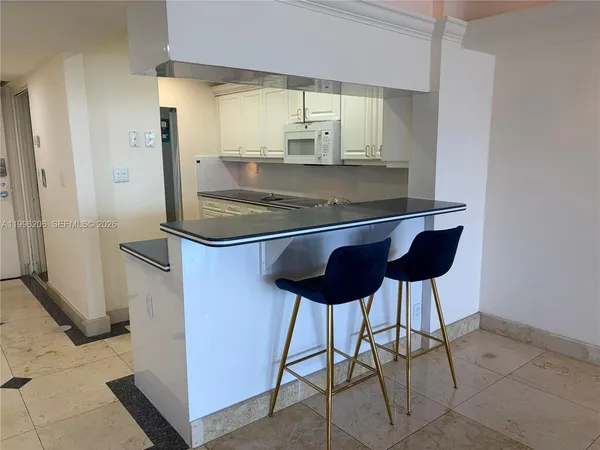 a living room with furniture a flat screen tv and a window