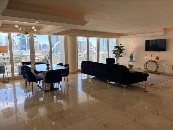 a spacious bedroom with a bed and large windows