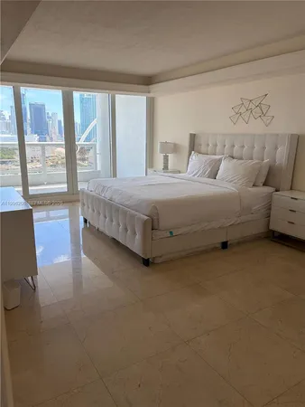 a bathroom with a granite countertop sink mirror and bathtub