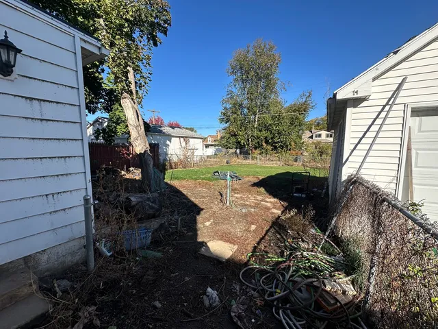 a view of a backyard with sitting area