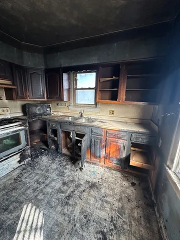 a kitchen with a stove and a refrigerator