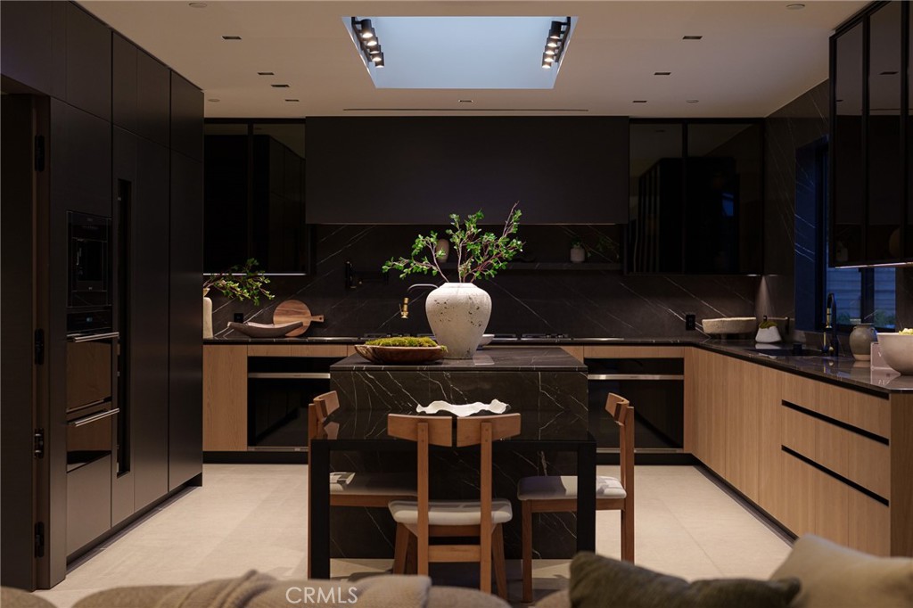 3187 Oakdell Road Studio City, CA 91604 - Photo 28 of 63 a kitchen with a table chairs and a refrigerator