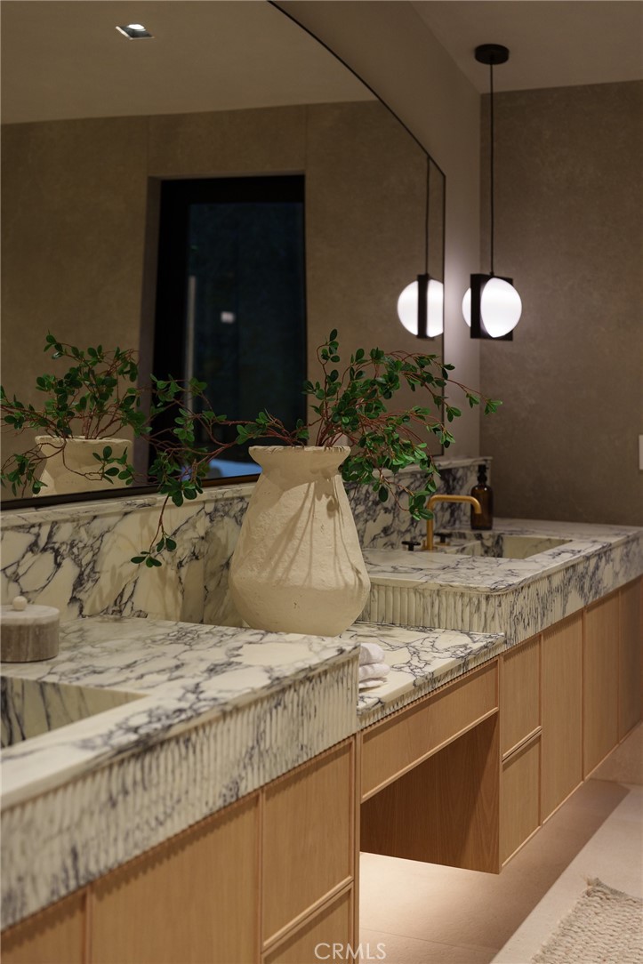 3187 Oakdell Road Studio City, CA 91604 - Photo 47 of 63 a bathroom with a granite countertop sink and a mirror