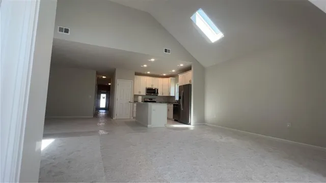a kitchen with stainless steel appliances granite countertop a refrigerator and a stove