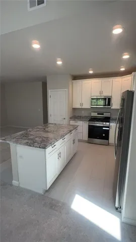 a view of empty room with a fireplace