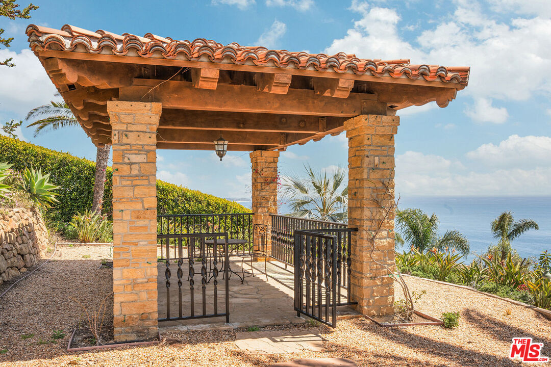 4440 Encinal Canyon Road, Unit GH Malibu, CA 90265 - Photo 12 of 16 a view of a terrace with a table and chairs