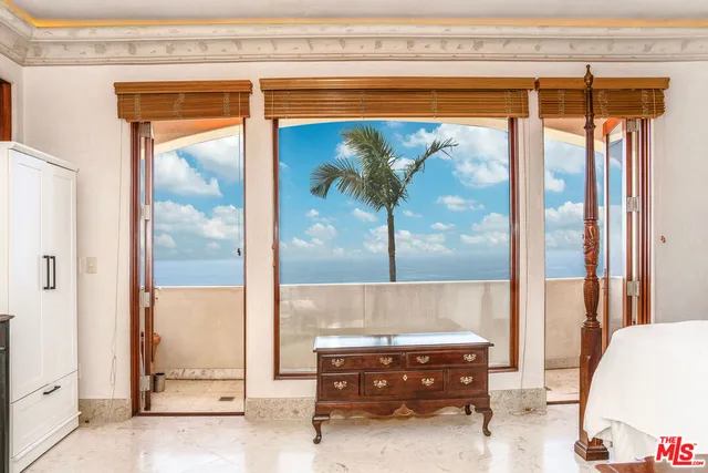 a living room with a glass door and furniture