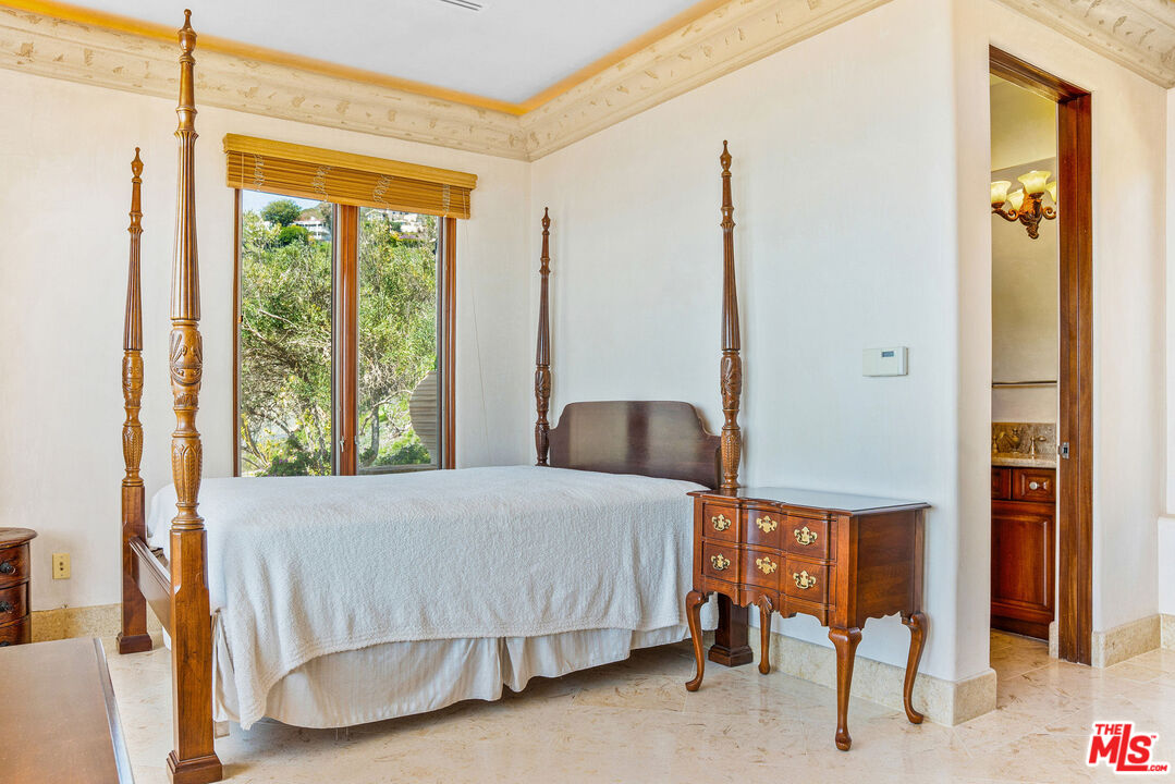 4440 Encinal Canyon Road, Unit GH Malibu, CA 90265 - Photo 7 of 16 a bedroom with a bed and a window