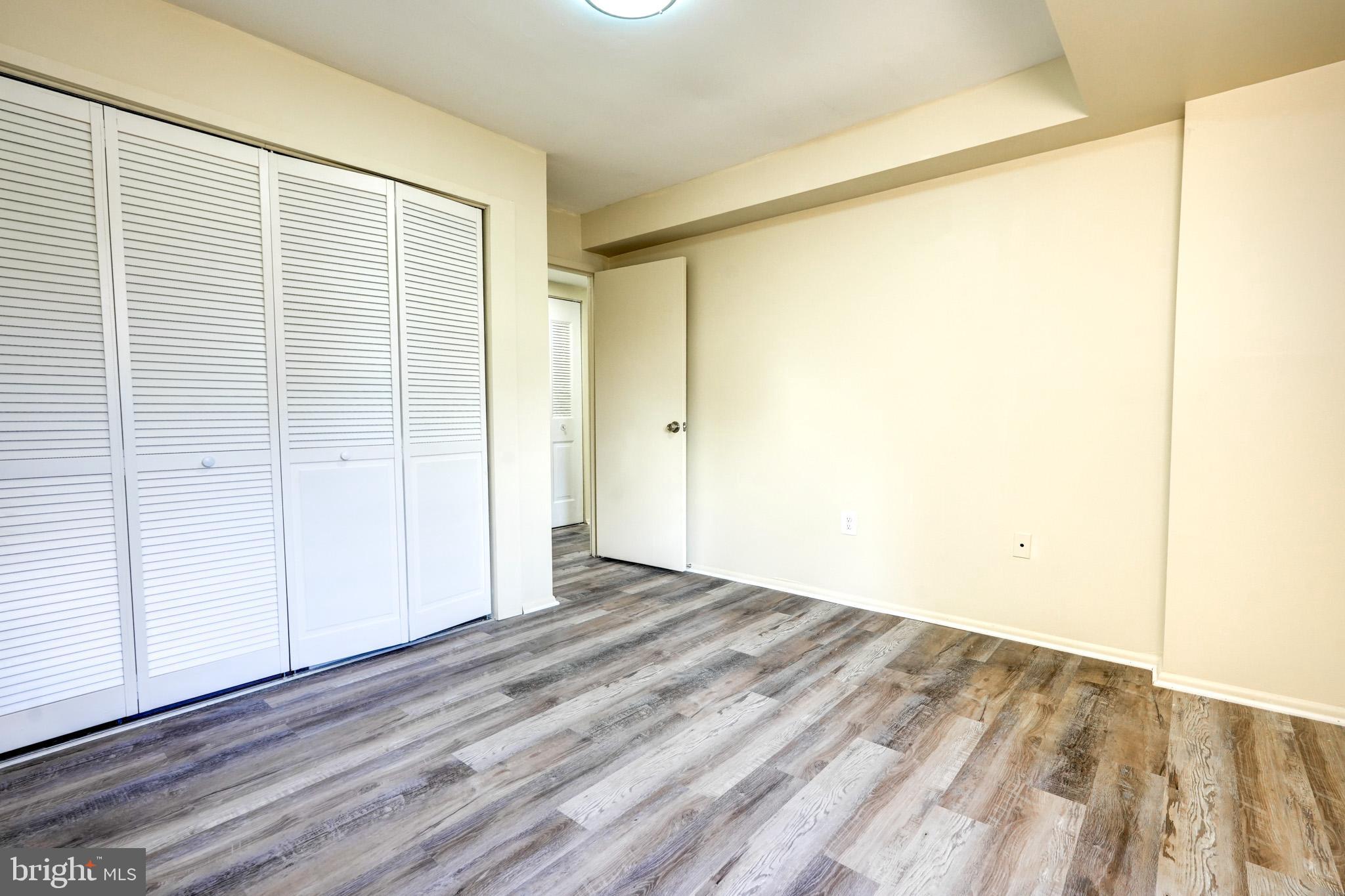 415 Christopher Avenue, Unit 11 Gaithersburg, MD 20879 - Photo 23 of 36 a view of an empty room with wooden floor