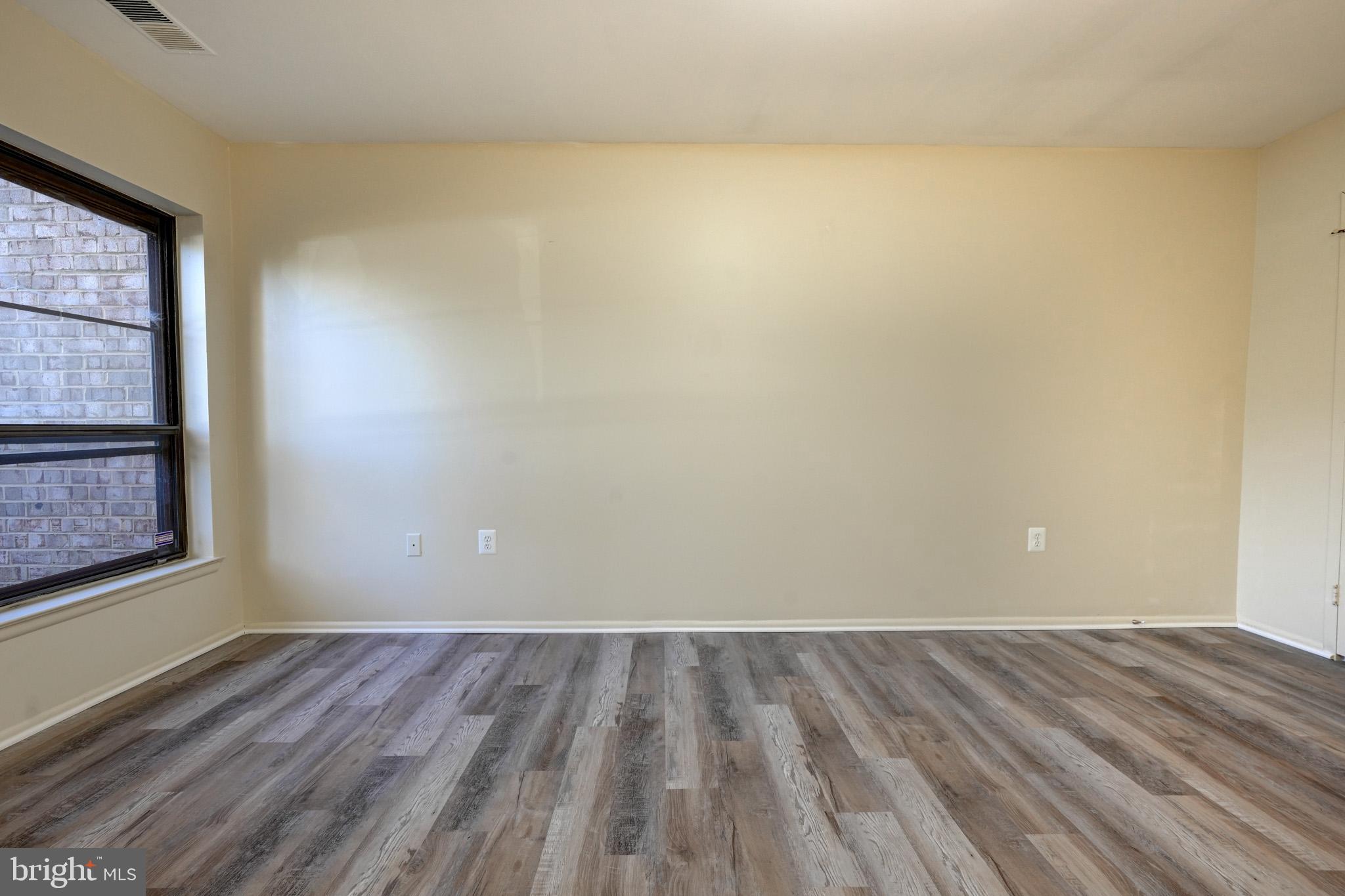 415 Christopher Avenue, Unit 11 Gaithersburg, MD 20879 - Photo 26 of 36 a view of a room with wooden floor and a window