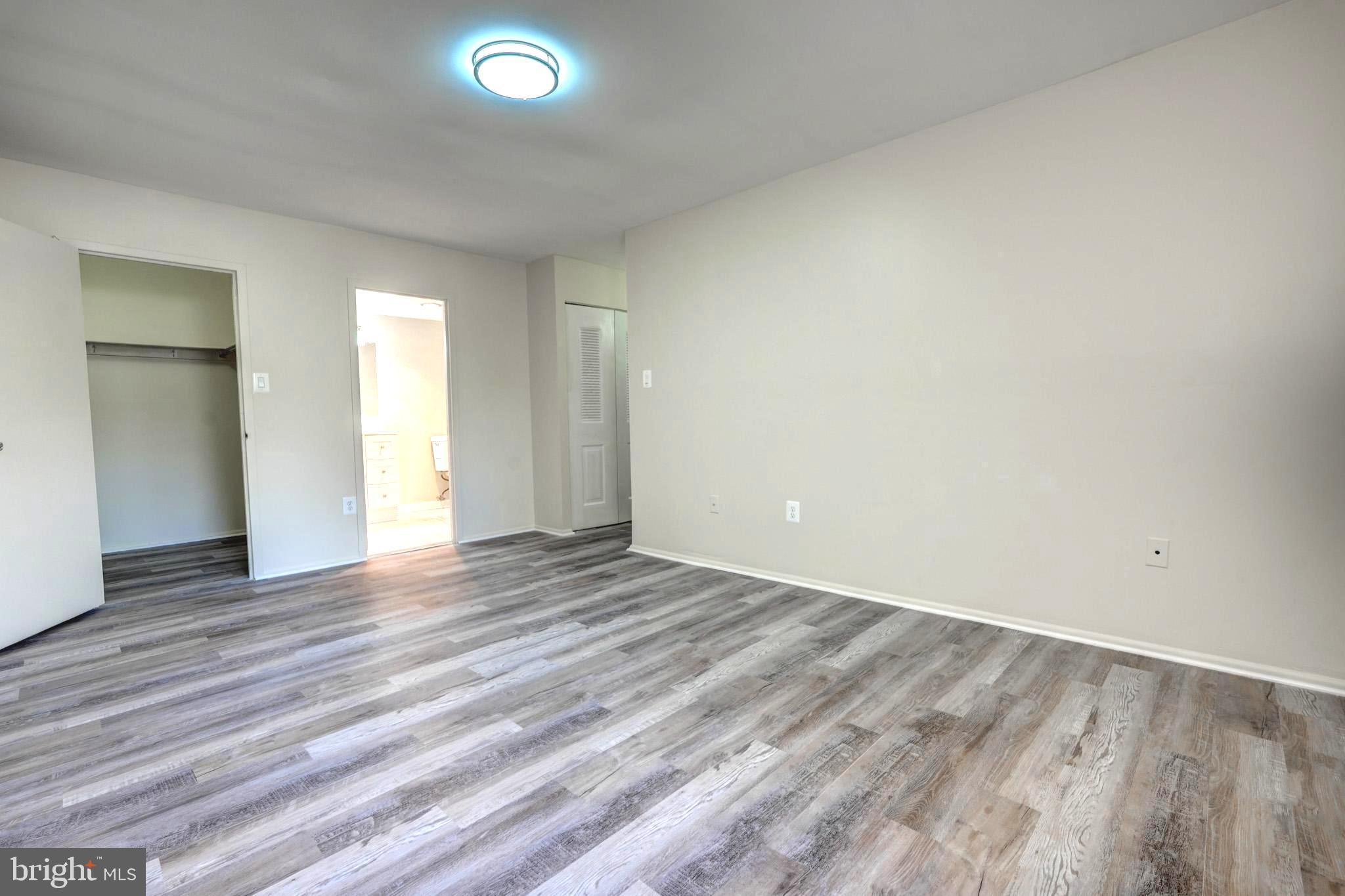415 Christopher Avenue, Unit 11 Gaithersburg, MD 20879 - Photo 28 of 36 a view of an empty room and wooden floor
