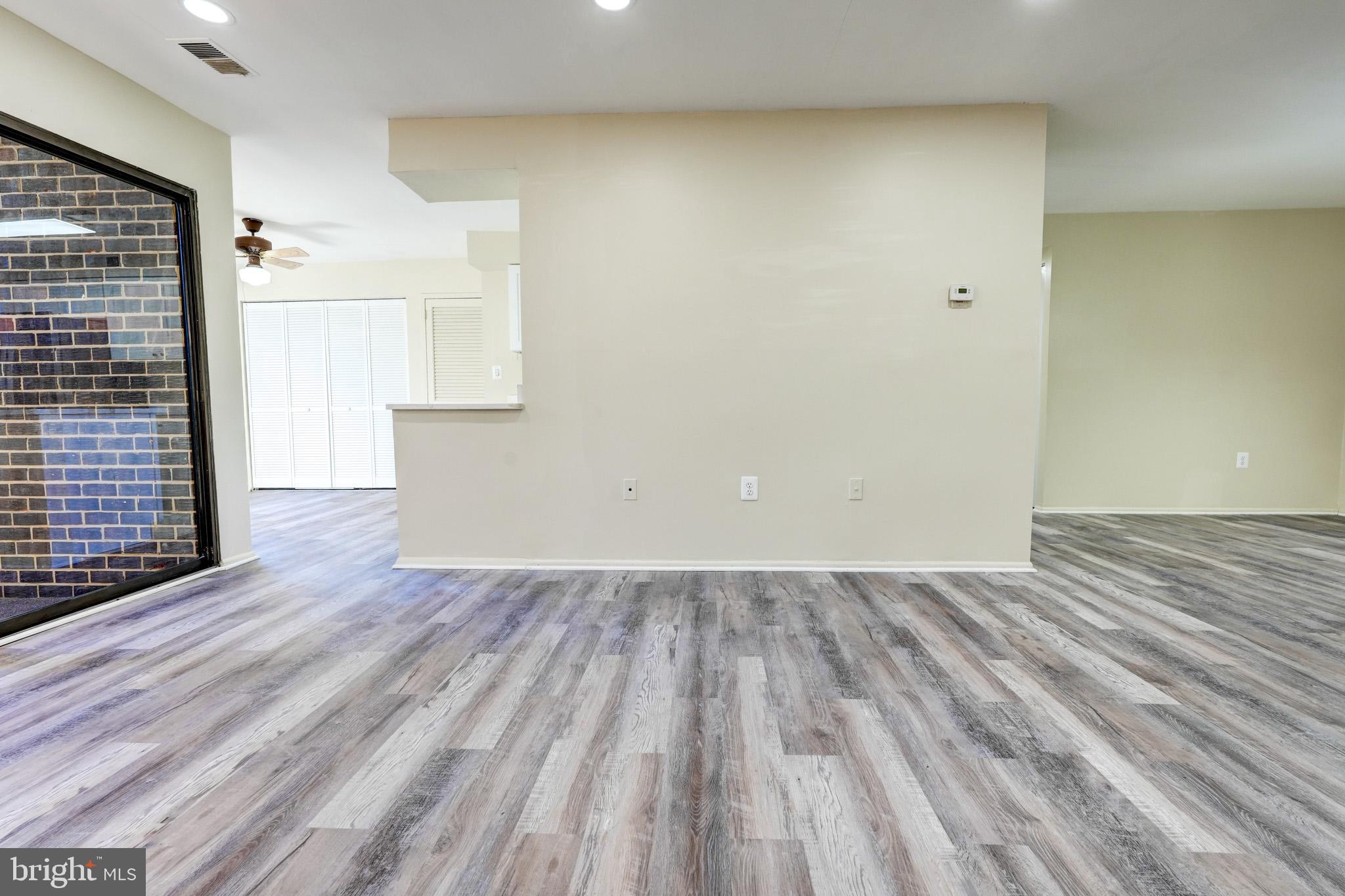 415 Christopher Avenue, Unit 11 Gaithersburg, MD 20879 - Photo 7 of 36 a view of empty room with wooden floor and fan
