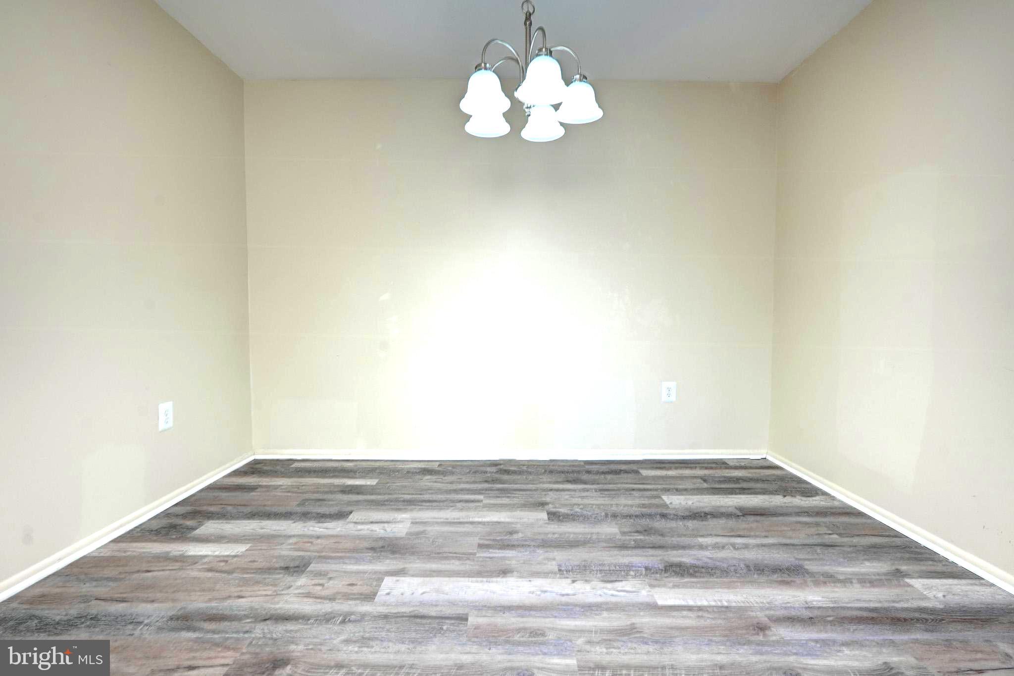 415 Christopher Avenue, Unit 11 Gaithersburg, MD 20879 - Photo 8 of 36 a view of an empty room with a chandelier fan