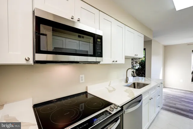 a kitchen with a sink cabinets and microwave