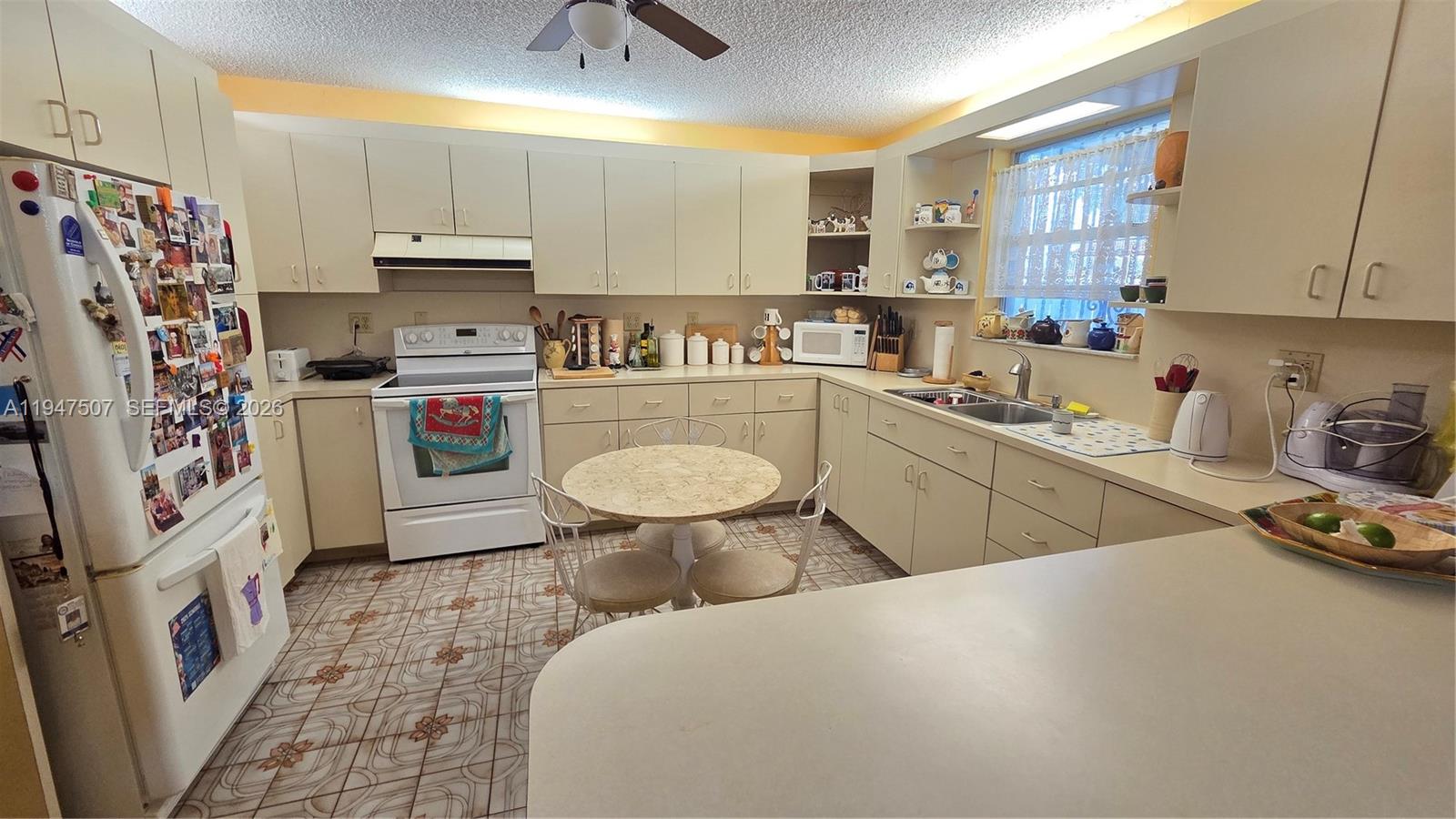 11933 Southwest 196th Terrace Miami, FL 33177 - Photo 13 of 29 a kitchen with a sink appliances and cabinets