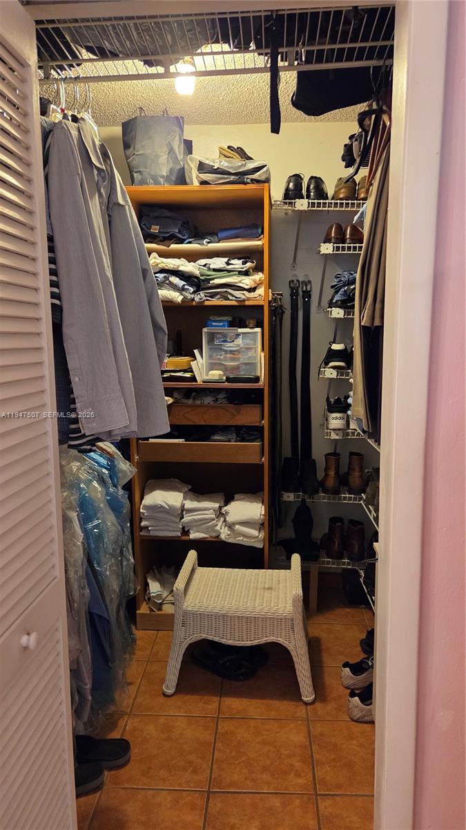 11933 Southwest 196th Terrace Miami, FL 33177 - Photo 15 of 29 a view of walk in closet with clothes and shoes