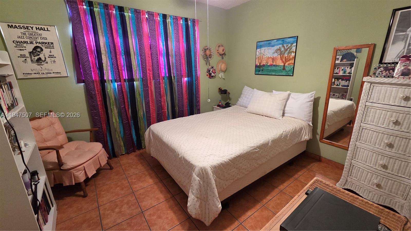 11933 Southwest 196th Terrace Miami, FL 33177 - Photo 16 of 29 a bed room with a bed and a chair