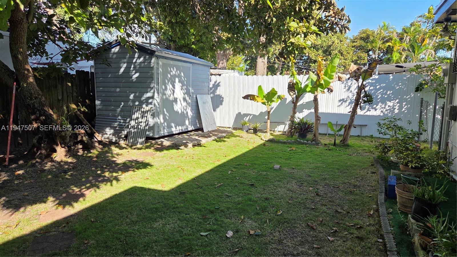 11933 Southwest 196th Terrace Miami, FL 33177 - Photo 24 of 29 a backyard of a house with lots of green space