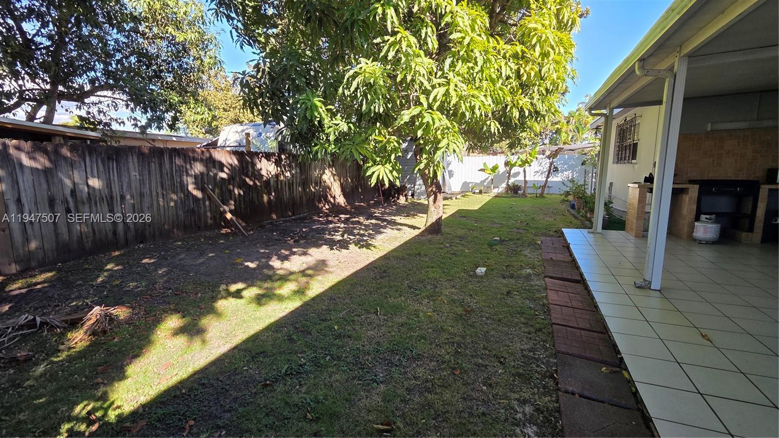 11933 Southwest 196th Terrace Miami, FL 33177 - Photo 27 of 29 a backyard of a house with lots of green space